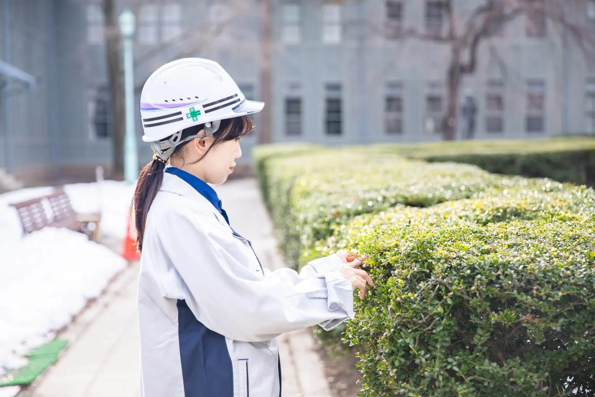 作業着とヘルメットを身につけている女性